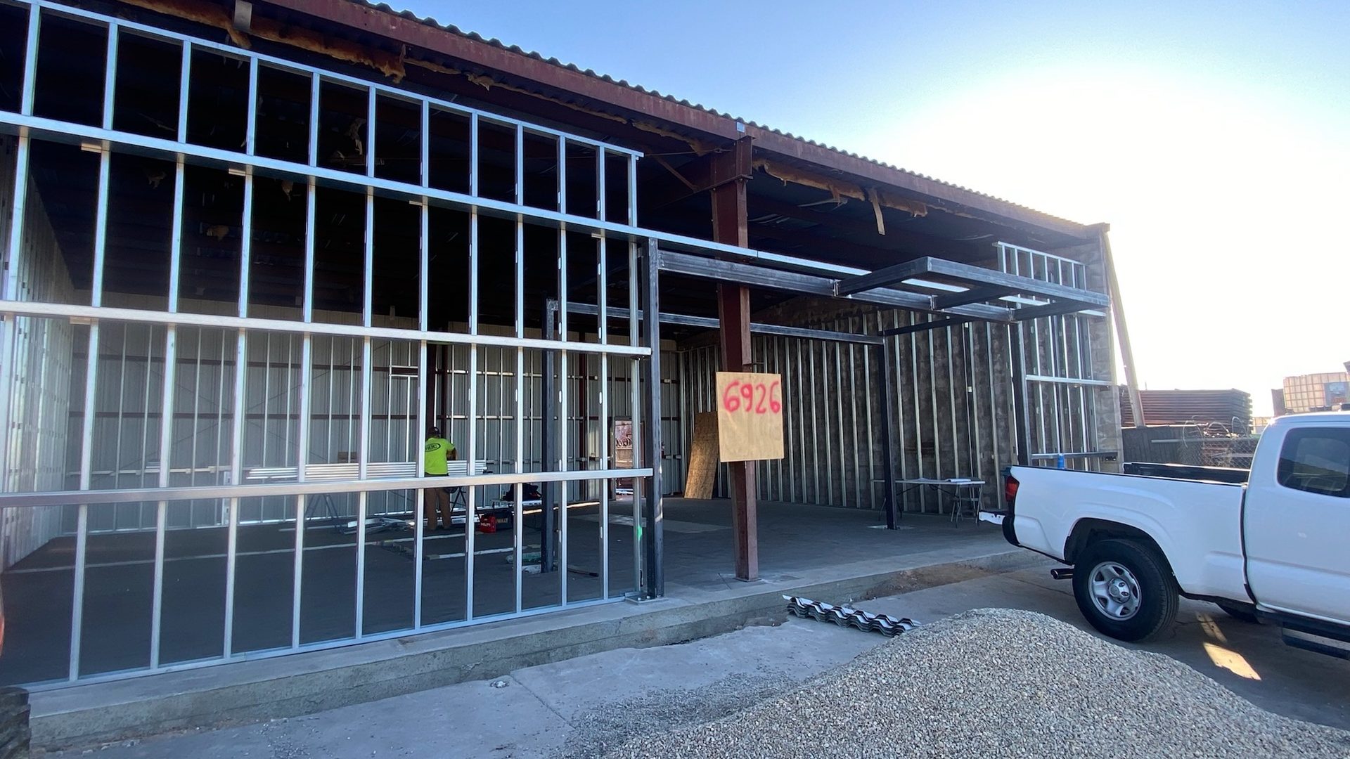 Drake Contracting design-build construction in progress, steel framing with windows installed, Fresno commercial project